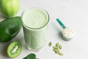 Green detox smoothie, blended vegetarian drink, protein milkshake in a glass from spinach, banana,...