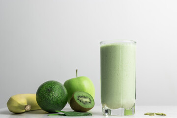 Green detox smoothie, blended vegetarian drink, protein milkshake in a glass from spinach, banana,...