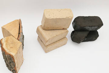 Alternative fuel, eco fuel, bio fuel. Wooden briquettes and firewood vs Peat briquettes on white...