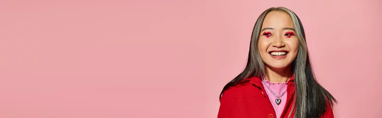Foto op Plexiglas Valentines day banner, happy asian woman with heart shaped eye makeup posing on pink backdrop © LIGHTFIELD STUDIOS