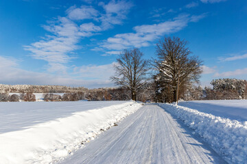 Fototapeta na wymiar Road in the countryside after heavy snowfall in central Europe