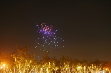 performance of light drone flying on sky arranging lotus flower at Suan Luang Rama 9 public park in...