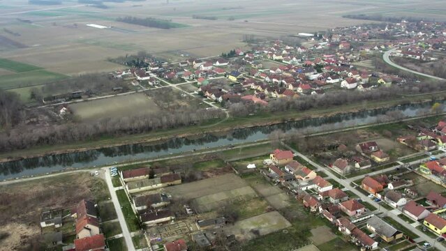 Aerial footage of residential area of small town Bac with canal in the middle