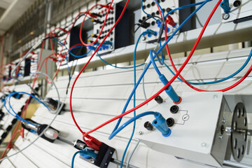 Electronic and magnetic panel with blue and red wires.