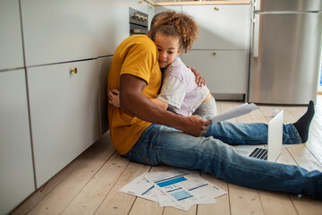 Daughter hugging father during financial bill crisis debt at home