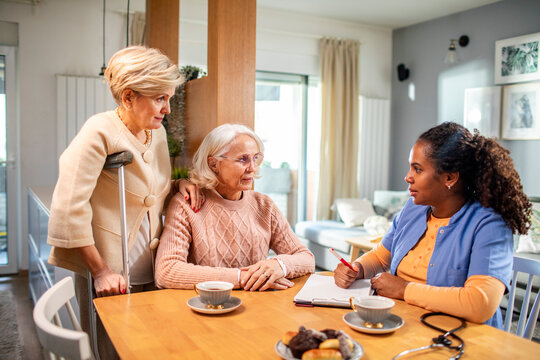 Senior women talking to caregiver at home