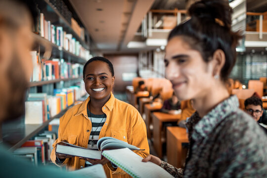 Diverse students studying together in the library