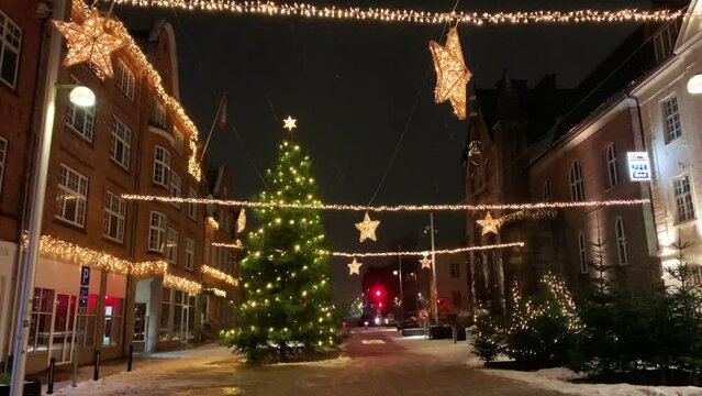 Copenhagen decorated for Christmas holidays, Denmark, Viborg, Shopping street in historical center of Aarhus decorated for New Year holidays, Pedestrians Christmas shopping on Stroget at night.