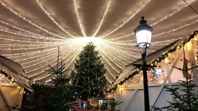 Copenhagen decorated for Christmas holidays, Denmark, Viborg, Shopping street in historical center of Aarhus decorated for New Year holidays, Pedestrians Christmas shopping on Stroget at night.