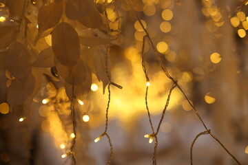 Golden blurred bokeh lights on black background. Glitter sparkle stars for celebrate. 