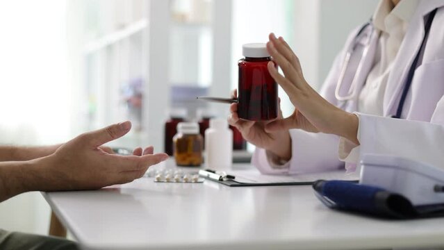Female doctor is explaining taking medicine to a patient. Health and health care consultation by specialist doctors in hospitals. Pharmacist gives medicine to patient.