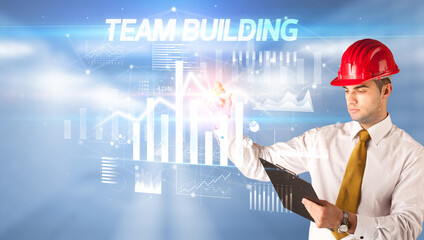 Young businessman with helmet drawing on virutal screen