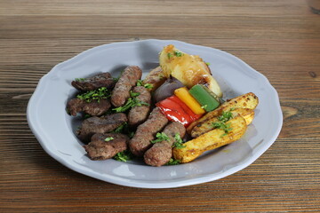 Tikka Kebab and kofta mix with potato veggies and salad served in dish isolated on table top view of arabic food