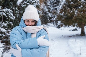 portrait of the woman get frozen outdoors at cold winter day