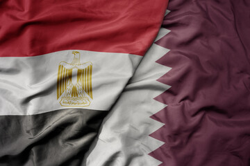 big waving national colorful flag of qatar and national flag of egypt . - obrazy, fototapety, plakaty