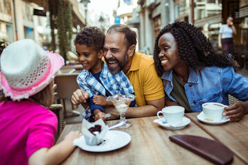 Multicultural Family Enjoying Desserts at an Outdoor Cafe