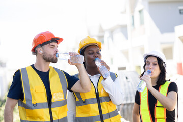 Healthy worker engineer team thirsty drinking clean water in hot temperature weather summer season...