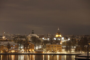 Fototapeta na wymiar Stockholm City Center Winter photo from Fjällgatan towards Skeppsholmen. Lights are on GoranOfSweden