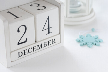 24 th December. White block calendar presents date 24 and month December, website events.  Winter...