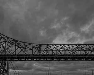 Greyscale shot of a bridge against the backdrop of a cloudy sky. Chicago, IL