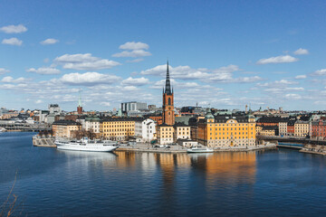 panoramic view of rooftops and view of the town hall tower with many colorful houses in stockholm...