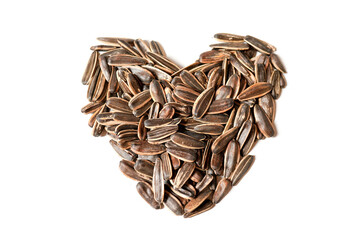 Delicious sunflower seeds in the shape of a love symbol isolated on a white background