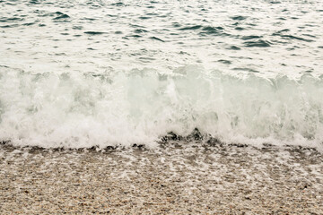 Nature. A sea wave hits the stone shore