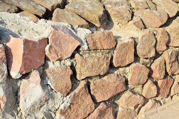 Fragment of a wall made of natural stone