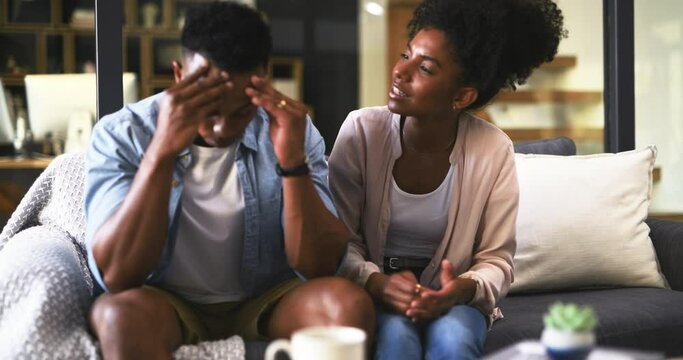 Man, woman and conflict in marriage on sofa, anxiety and fighting with stubborn partner in communication fail. Black couple, young and relationship problem, stress and risk of divorce in living room