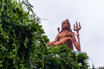 hindu god lord shiva isolated statue with bright background at morning from unique perspective