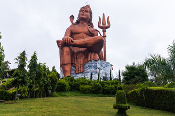 hindu god lord shiva with shivalinga isolated statue with bright background at morning