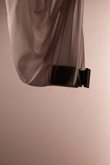 Perfume bottle on silk folded fabric background. Scent fragrance cosmetic beauty product promo