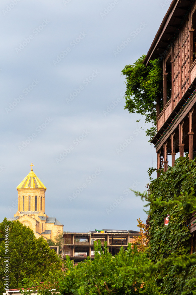 Wall mural travel to Georgia - golden cupola of cathedral and gray cloudy autumn sky in Tbilisi city