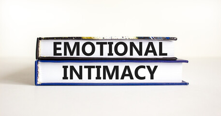 Emotional intimacy symbol. Concept words Emotional intimacy on beautiful books. Beautiful white table white background. Psychology emotional intimacy concept. Copy space.