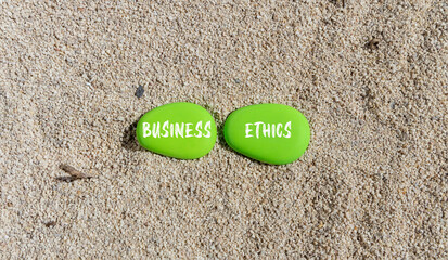 Business ethics symbol. Concept words Business ethics on beautiful green stone. Beautiful sand beach background. Business ethics concept. Copy space.