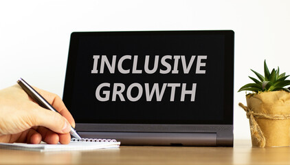 Inclusive growth symbol. Concept words Inclusive growth on beautiful black tablet. Beautiful white background. Businessman hand. Business inclusive growth concept. Copy space.