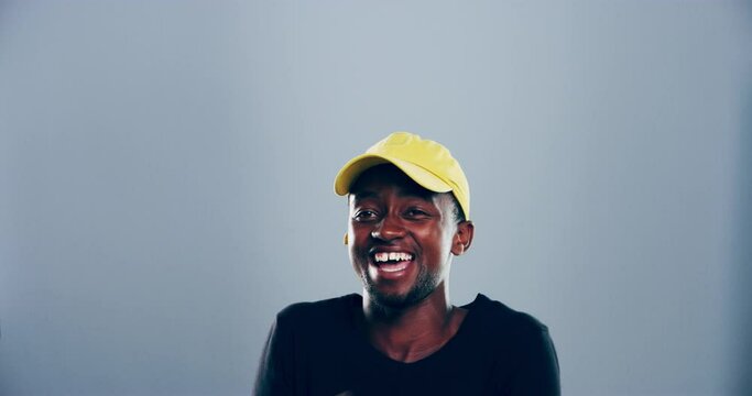 Man, face and laugh in studio with happy expression, cheerful joke and humor on grey background. Portrait, african model and clapping hands for comedy, silly news and funny emoji reaction to meme