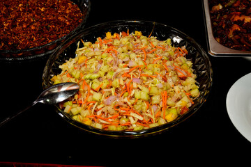 Salad with radishes, tomatoes and Apple on a plate