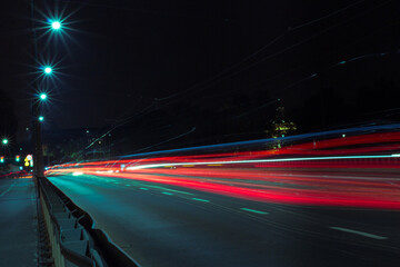 Fototapeta na wymiar Blurry lights from the headlights of cars on the road