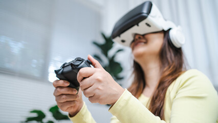 Young Asian woman wearing virtual reality touching air during the VR experience  Future technology concept.