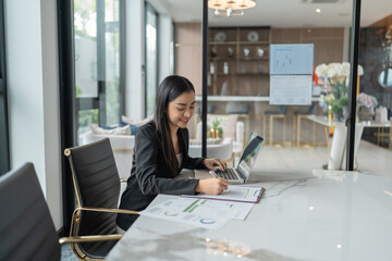 Beautiful confident asian business woman working with laptop Hands typing  keyboard. Professional investor working new start up project. business planning in office. Technology business