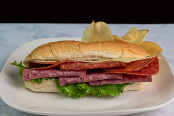 salami  and pepperoni sub served with potato chips,