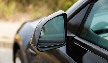 car mirror reflecting cityscape, symbolizing travel, reflection, urban lifestyle, and exploration....