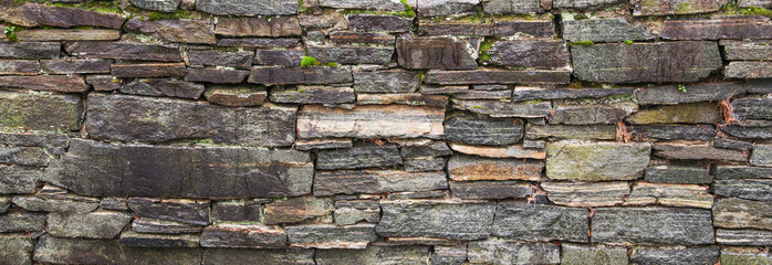 Stone texture close-up, rugged surface with natural imperfections, symbolizing durability, strength, timelessness. Ideal for architectural, nature, or background concepts