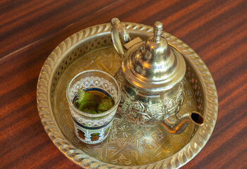 Fototapeta na wymiar Moroccan Mint Tea in Teapot and Glass