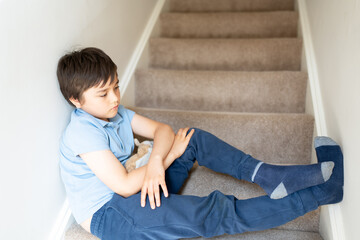 Portrait kid looking out deep in thought, Lonely Child sitting on stairs carpet with thinking face, Childhood and family concept, Selective focus Emotional kid image