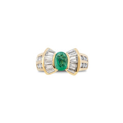 Green emerald ring with diamonds on a white background. Top view on luxury jewelry.