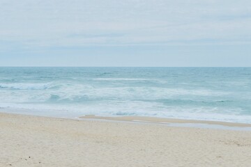 ocean waterfront beach on moody windy day in Portugal. Faded peaceful background