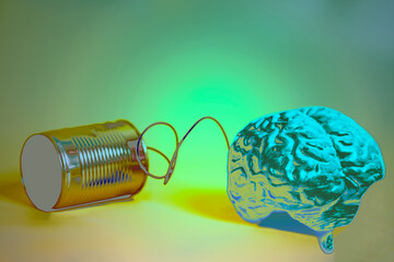tin can phone with human brain anatomical model. communication concept