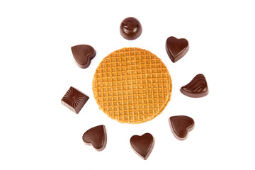 Chocolates and Belgian waffles isolated on a white background.
